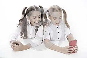 Blog for students. Little children typing new blog post from smartphone. Small bloggers keeping class blog. Smart girls