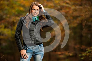 Blog style pretty young woman on a walk in forest on late autumn