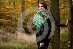 Blog style pretty young woman on a walk in forest on late autumn