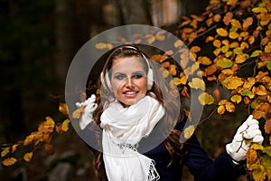 Blog style pretty young woman on a walk in forest on late autumn