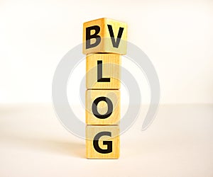 Blog or Vlog symbol. Turned a wooden cube and changed the word Blog to Vlog. Beautiful white table white background. Business and