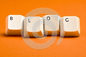 Blog White Keyboard Keys on Orange