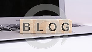 BLOG - wooden cubes with letters on a laptop keyboard