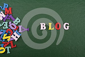 BLOG word on green background composed from colorful abc alphabet block wooden letters, copy space for ad text. Learning