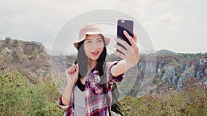 Blogger Asian backpacker woman record vlog video on top of mountain, young female happy using mobile phone make vlog video enjoy