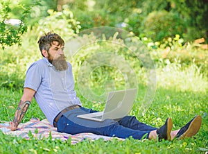 Blogger becoming inspired by nature. Looking for inspiration. Man bearded with laptop relaxing meadow nature background