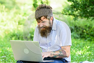 Blogger becoming inspired by nature. Man bearded with laptop sit meadow nature background. Writer looking for
