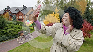 Blogger filming herself for a vlog in picturesque park with colorful foliage