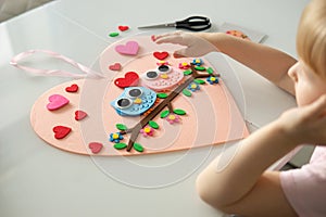 A blogger girl makes a felt craft for Valentine& x27;s Day in the shape of a heart. The concept of children& x27;s