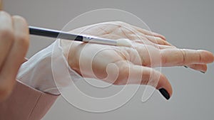 Blogger hand showing brush at apartment vertically closeup. Woman recording blog