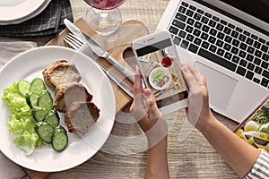 Blogger taking photo of food with mobile phone