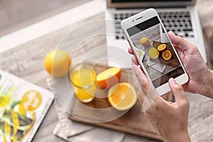 Blogger taking photo of food with mobile phone, closeup