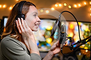 The blogger works with a studio microphone, podcasts, voice acting, audio books photo
