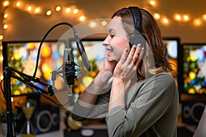 The blogger works with a studio microphone, podcasts, voice acting, audio books photo