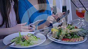 Bloggers girlfriends take photo of beautiful meal on smartphone during healthy lunch during diet for weight loss in