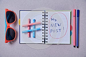 Blogging, blog and blogger or social media concept: notepad and hashtag symbol on grey background