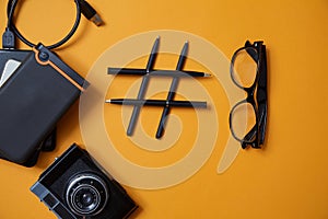 Blogging, blog and blogger or social media concept: symbol hashtag and different accessories for blogger. Flat lay