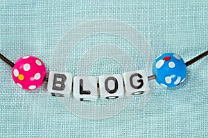 Blogging concept - letters on blue fabric