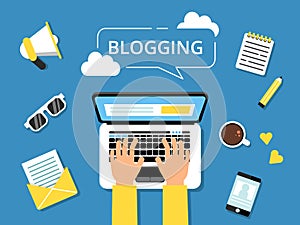 Blogging concept picture. Hands on laptop and various tools for writers around