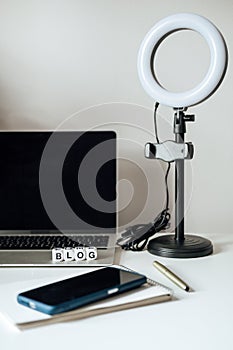 Blogging Equipment. How To Start Blog, Blogging for Beginners. Laptop, Mobile Phone, Ring Light, notebook and glasses on