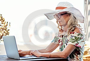 Blogging has become her new habit. an attractive senior woman using a laptop while sitting outside at home.