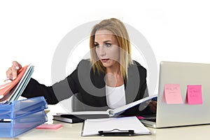 Blond attractive 40s woman in business suit working at laptop co