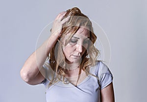 Blond attractive woman on her thirties sad and depressed looking desperate in sorrow