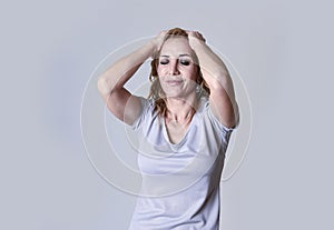 Blond attractive woman on her thirties sad and depressed looking desperate in sorrow