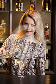 Blond bartender making cocktail