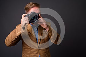 Blond bearded businessman with goatee against gray background