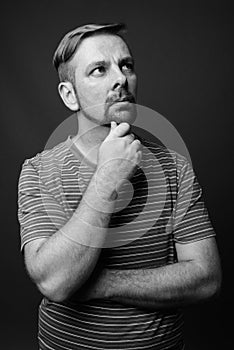 Blond bearded man with goatee against gray background