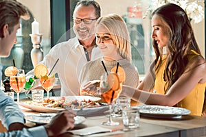 Blond beautiful woman having lunch with her best friends at a trendy restaurant