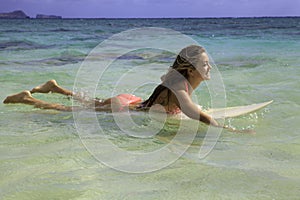 Blond in bikini on her surfboard