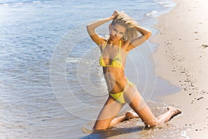 blond bikini model on a beach