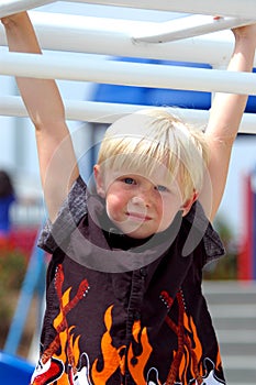 Blond Boy Child On Bars