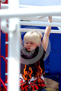 Blond Boy Child On Bars