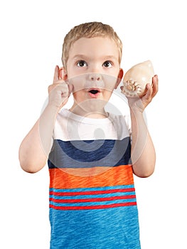 Blond boy listening to seashell. isolated on white