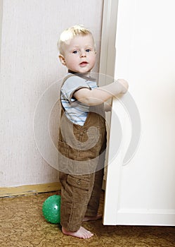 Blond boy playing in room