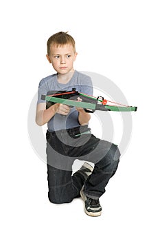 Blond boy shooting a crossbow