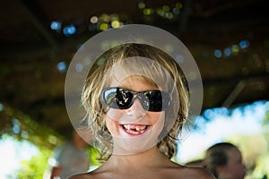 Blond boy smiling.