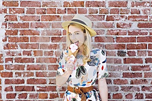 Blond Caucasian Girl Licks Ice Cream Against a Brick Wall Cone Fedora Hat