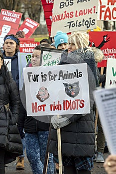 Blond caucasian woman hold no sign in her hand in the crowd of activists at Animal Advocacy protest