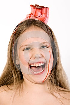 Blond child with desert on her head laughing