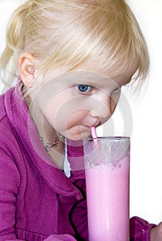 Blond child drinking milkshake