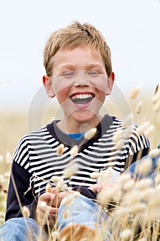 Blond child laughing in nature