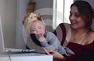 blond child is sleeping in a large gold crown