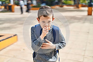 Blond child student coughing at park