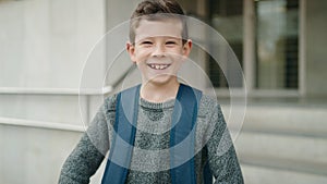 Blond child student smiling confident standing at school