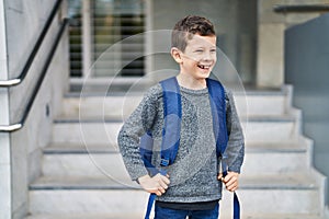 Blond child student smiling confident standing at school