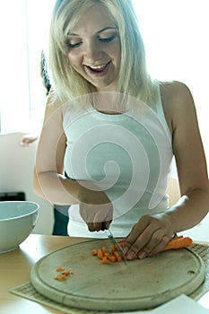 Blond chopping carrots photo